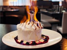 a white plate topped with a cake covered in whipped cream