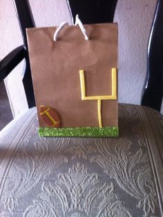 a brown paper bag with the letter h on it sitting on top of a chair