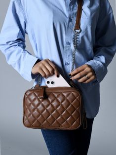 Introducing our Brown Quilted Shoulder Bag - a triumph in sophistication. This brown leather sling bag boasts a mesmerizing diamond texture, radiating luxury at every angle. Its sleek rectangular shape, coupled with a silver chain intricately combined with a leather strap, ensures both style and shoulder support. Featuring two compartments secured with zippers, it effortlessly blends practicality with opulence. Ideal for western ensembles, this bag is your statement piece for brunch, lunch, or a Rectangular Business Shoulder Bag With Chain Strap, Business Rectangular Bag With Chain Strap, Quilted Brown Evening Bag, Brown Quilted Evening Bag, Formal Brown Quilted Shoulder Bag, Brown Quilted Leather Shoulder Bag, Rectangular Leather Bag With Diamond Quilting, Shoulder Support, Leather Sling Bag