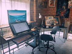 a laptop computer sitting on top of a desk next to a desktop computer monitor and keyboard