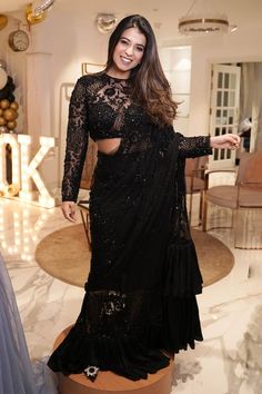 Black pre-draped saree crafted in net and satin silk with midnight bloom garden embroidery using tonal sequins, beads highlights and frilly ruffle detailing on the saree skirt and pallu. Paired with a full sleeves sequin fleur garden embroidered sheer blouse. - Aza Fashions Black Saree With Full Sleeve Blouse, Embellished Pre-draped Saree For Diwali Evening, Evening Embellished Pre-draped Georgette Saree, Glamorous Evening Choli In Georgette, Glamorous Evening Georgette Choli, Glamorous Party Blouse With Intricate Embroidery, Elegant Floor-length Sequined Blouse Piece, Evening Blouse With Resham Embroidery For Diwali, Elegant Georgette Sequin Fabric For Designer Wear