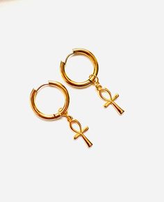 - Stainless steel hoop ,24K gold plated  Egyptian cross earrings , gold cross earrings - The diameter of earrings is 2 cm (0,8 inches), cross charm length is 2.7 cm (1,1 inches), total length of earrings is 4.7 cm (1,8 inches) - Colors may appear slightly different on screen due to differences in resolution, brightness, and contrast JEWELRY CARE - Keep jewelry dry - Take it off before taking shower, bath, swimming or exercising - Makeup, perfume, hairspray apply before wearing jewelry - Store yo Nickel-free Ankh Gold Earrings, Contrast Jewelry, Gold Cross Earrings, Egyptian Gold, Egyptian Cross, Wearing Jewelry, Egyptian Mythology, Cross Earrings, Cross Charms