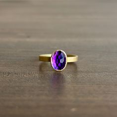 Deep purple hues flicker from within its noble gold frame in this beguiling amethyst ring. 18k yellow gold Amethyst, 1.89ct, 7mm x 9mm (1/4" x 5/16") Cast Rings, Elongated Oval, Chalcedony Ring, Newport Rhode Island, Purple Hues, Stacking Ring, Amethyst Ring, Unique Necklaces, Stacking Rings