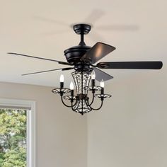 a chandelier hanging from the ceiling in a room with white walls and windows