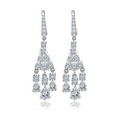 pair of white gold earrings with diamonds on the bottom and dangling from each earring