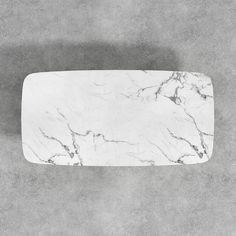 a white marble tray on a gray background