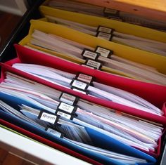 an open file cabinet filled with files and folders