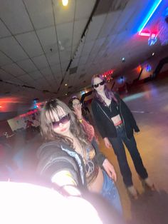 three women in sunglasses are posing for the camera