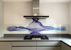 a stove top oven sitting inside of a kitchen next to a wall mounted range hood