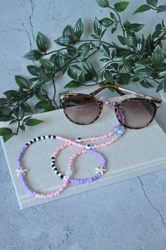 Say goodbye to losing your glasses with this cute pastel coloured glasses chain. The chain features perfect-quality lilac seed beads, marble effect beads and plated connectors for the finish which will make you happy each time you put them on! These Beaded Glasses Chains are a fun way to keep your shades safe and sound. Plus, you can use this eyeglass chain as an oversized necklace or wrap it around your neck for a regular-size necklace. All you have to do is attach two clasps together and voila Trendy White Glasses Chains With Colorful Beads, Trendy Pastel Jewelry For The Beach, Trendy Glasses Chains With Round Beads, Trendy Round Beads Glasses Chains For Beach, Handmade Pink Glasses Chains For Summer, Pink Glass Glasses Chains For Summer, Trendy Pink Glass Glasses Chains, Trendy Pink Glasses Chains As Fashion Accessory, Pink Glasses Chains For Beach And Summer