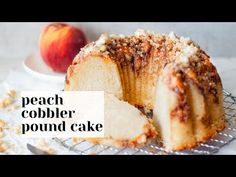 a piece of cake sitting on top of a cooling rack next to an apple slice