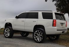 a white truck parked on the side of a road