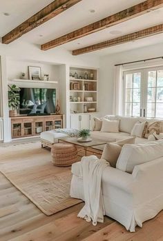 a living room filled with furniture and a flat screen tv on top of a wooden floor