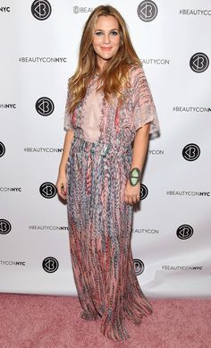 a woman standing in front of a red carpet