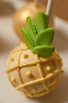 a small toy pineapple with green leaves on it