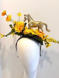 "Horse Fascinator- Day at the Races- Yellow Flower Headpiece - Mad Hatter- Kentucky Derby- Racing Fashion Hi,    This piece has a beautiful collection of yellow flowers on a faux green moss is about 6\" wide. The gold plastic horse is about 4' high.  It's placed on the top of a skinny  1/4 \" satin covered headband that fits any adult head size.   It's a little heavy so you may need a bobbie pins to hold it on.  -------------------------------------- If you like this try: https://doramarra.etsy.com/listing/1547668418 -------------------------------------------------- I ship US Postal Service. USA DOMESTIC CHOICES   (From mailed date in business days) First Class:  Arrives 3-6 days. (No insurance) Priority:        Arrives 1-3 days.  (Insurance included)                   Express:       Arri Diy Kentucky Derby Fascinator, Kentucky Derby Costume, Yellow Flower Hat For Spring, Yellow Flower-shaped Hats For Spring, Gold Fascinator For Spring Garden Party, Yellow Fascinator For Kentucky Derby Garden Party, Gold Costume Hats And Headpieces For Races In Spring, Gold Costume Hats And Headpieces For Spring Races, Gold Headpiece For Spring Races