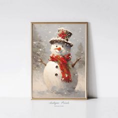 a snowman with a red scarf and hat on it's head is standing in front of a white wall