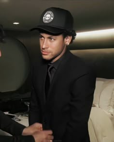 a man in a black suit and hat