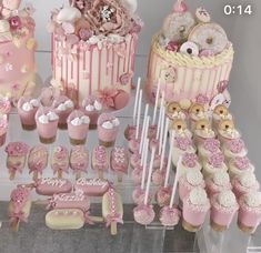 pink and white cake, cupcakes, candy bars and decorations