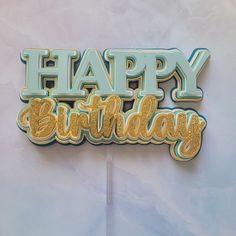 a happy birthday cake topper with the words happy birthday on it's side