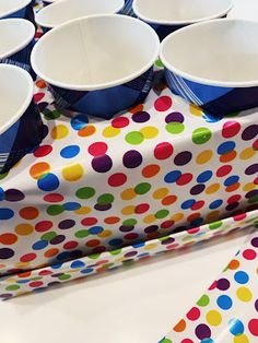 a table topped with lots of paper cups