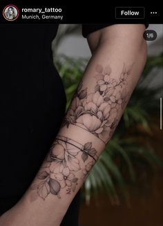 a woman's arm with flowers on it and the words temporary tattoos written in black ink