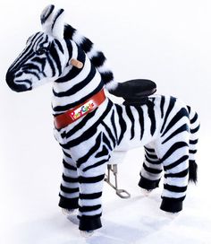 a stuffed zebra is standing next to a small toy bike on a white background with black and white stripes