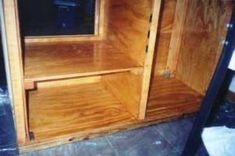 the inside of a wooden cabinet with its door open