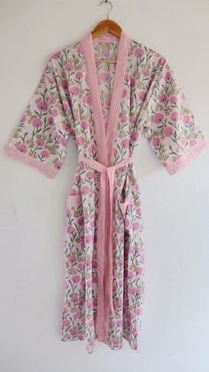 Cotton kimono robes which are perfect for lounging around the home or spa. Use our Hand Block Print robe as a cover up on the beach or after a dip in the pool. Add a luxe, boho feel to your bridal shower. Versatile, soft and luxurious, our 100% cotton kimono robes are printed with azo-free dyes. The printed robe features 3/4th sleeves, a waist tie and two front pocket. Material :- 100% Cotton Fabric Print :- Hand Block Print Size - One size will fit sizes S to XL Length - 48 inches (125 Centimeter), mid calf Note: Girl wear the kimono has height 5.3' feet and more Measurements Approx : *Length: 50" Inches *Bust Around Size: 48" Inches *Shoulder: 8" Inches *Sleeve Length: 14" Inches *2 Side Pockets For best results hand wash and line dry when possible. Machine wash cold, tumble dry low and Cotton Sleepwear For Wedding In Spring, Pink Kimono For Home Use In Spring, Pink Kimono For Home During Spring, Pink Spring Kimono For Home, Pink Floral Print Robe For Home, Pink Floral Print Home Robe, Summer Wrap Sleepwear For Home, White Spring Kimono For Relaxation, White Kimono Sleeve Sleepwear For Home