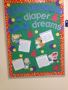 a bulletin board that says give someone a diaper full of dreams on the wall