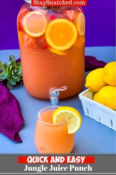 a jar filled with orange juice next to some lemons