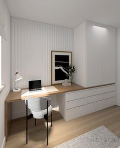 a desk with a laptop on top of it in front of a white wall and wooden floor