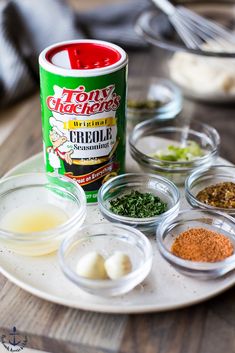 spices and seasonings on a plate next to a can