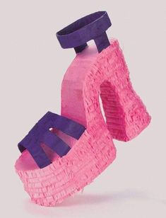 a pink and purple paper shoe sitting on top of each other