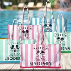 three personalized beach bags sitting next to a swimming pool with palm trees on them