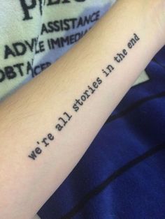 a person with a tattoo on their arm saying we're all stories in the end