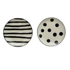 two black and white plates sitting next to each other