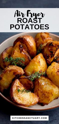 air fryer roast potatoes on a plate with rosemary garnish