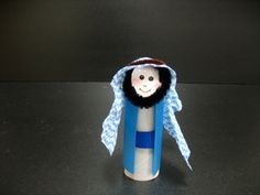 a small doll is sitting in a tube