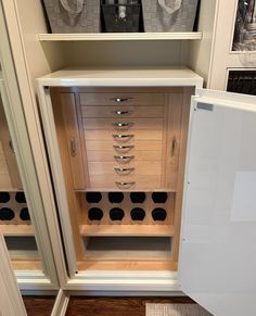 an empty wine cabinet with several bottles in it