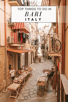 an alleyway with tables and chairs on the ground in front of buildings that read top things to do in bar i italy