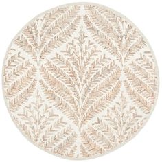 a round rug with leaves on it in beige and white colors, against a white background