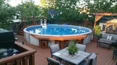 an above ground pool surrounded by patio furniture