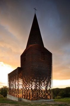 a large wooden building with a cross on top