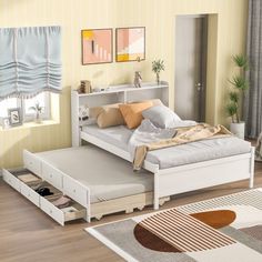 a white bed sitting on top of a hard wood floor next to a wall mounted book shelf