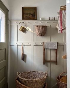 some baskets hanging on a white wall