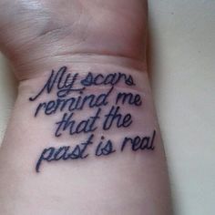 a wrist tattoo with the words my scars remind me that the past is real