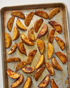 baked potato wedges on a baking sheet ready to be cooked in the oven for dinner