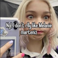 a woman taking a selfie with her cell phone and the caption says, no i don't rly like meane martenz