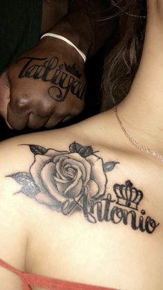 a woman with a rose tattoo on her chest and the word love written in cursive writing